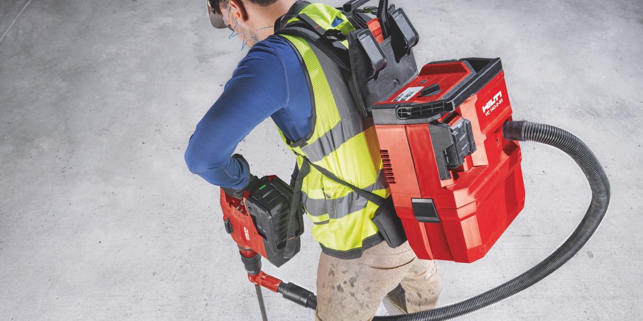 Construction worker using Hilti SafeSet installation method with VC 140-2-22 "vac-pack" vacuum and TE 60-22 cordless rotary hammer